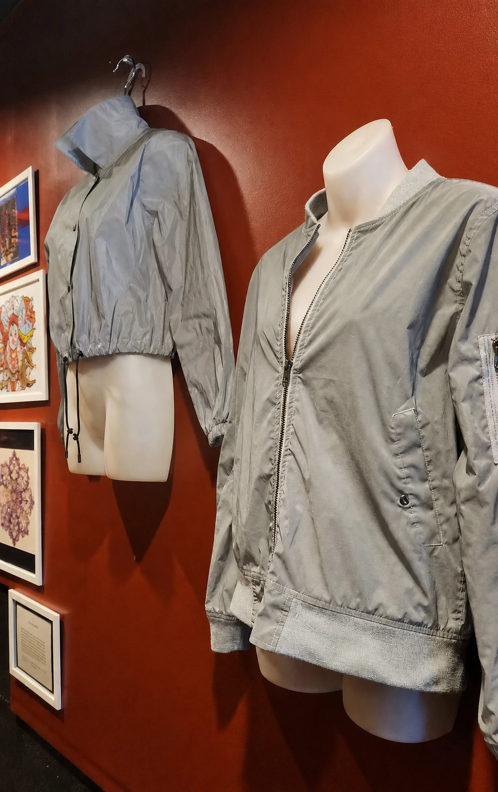 Second-use jackets displayed beside local artwork inside Bump N Grind Cafe