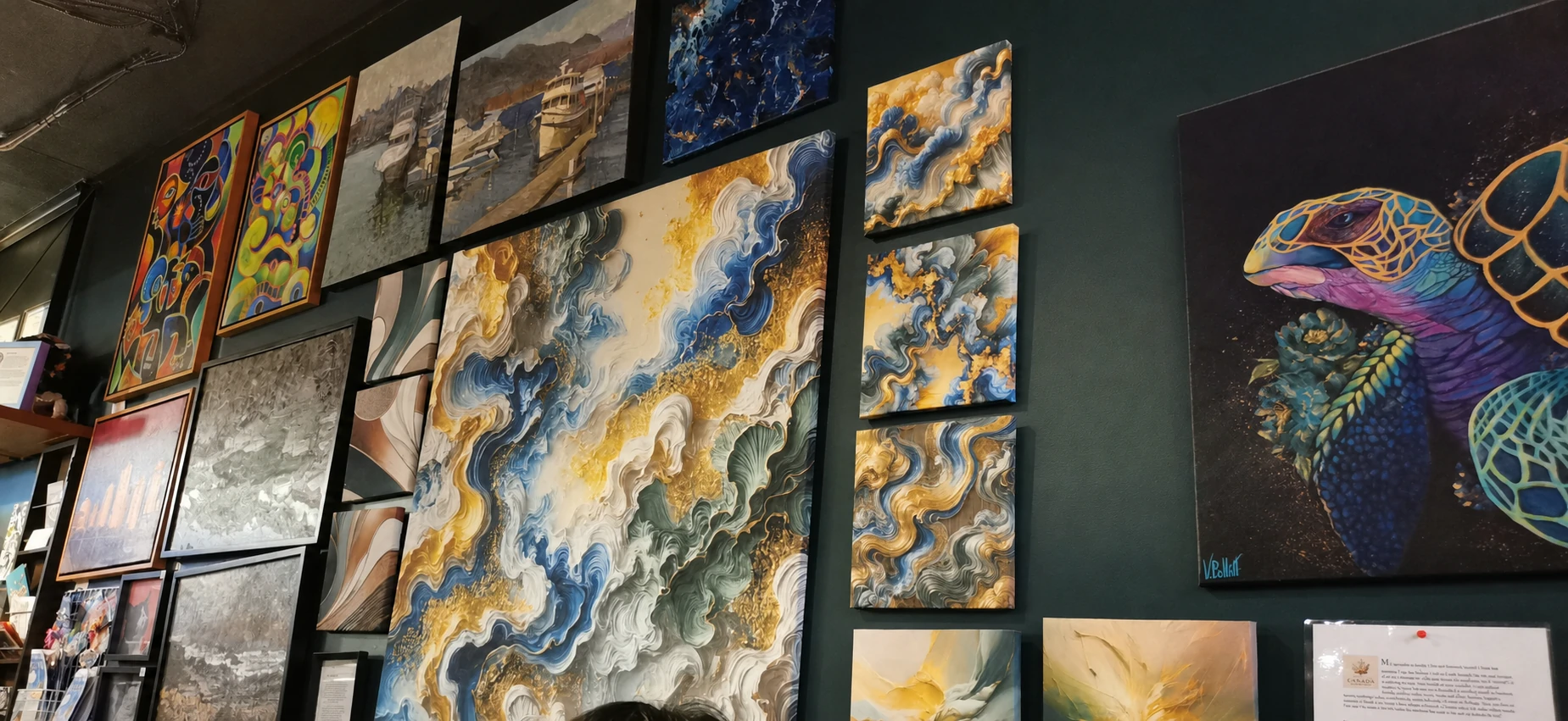 Wall of local artwork displayed inside Bump N Grind Cafe