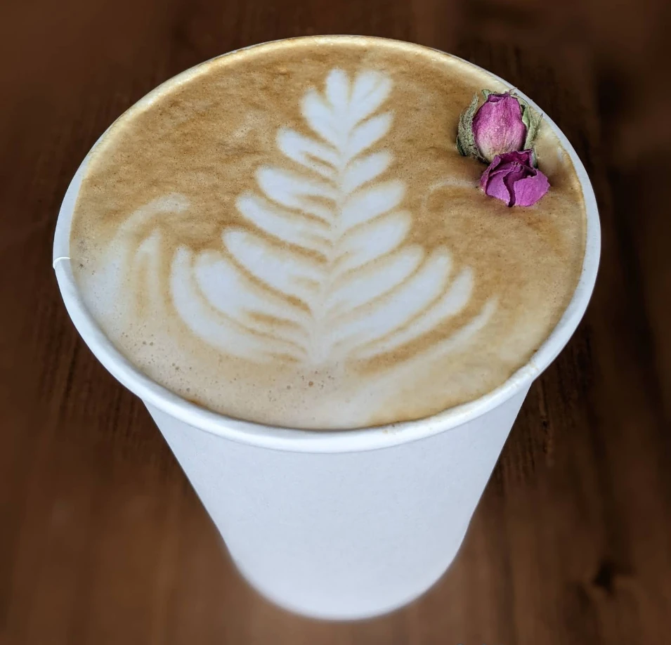 Latte with foam art and a rose garnish